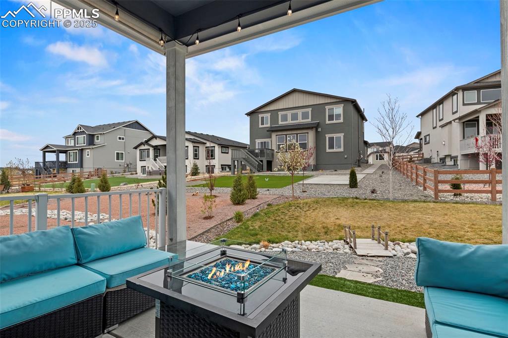 Image 37 of 38: View of patio / terrace with fence, an outdoor living space with a fire pit