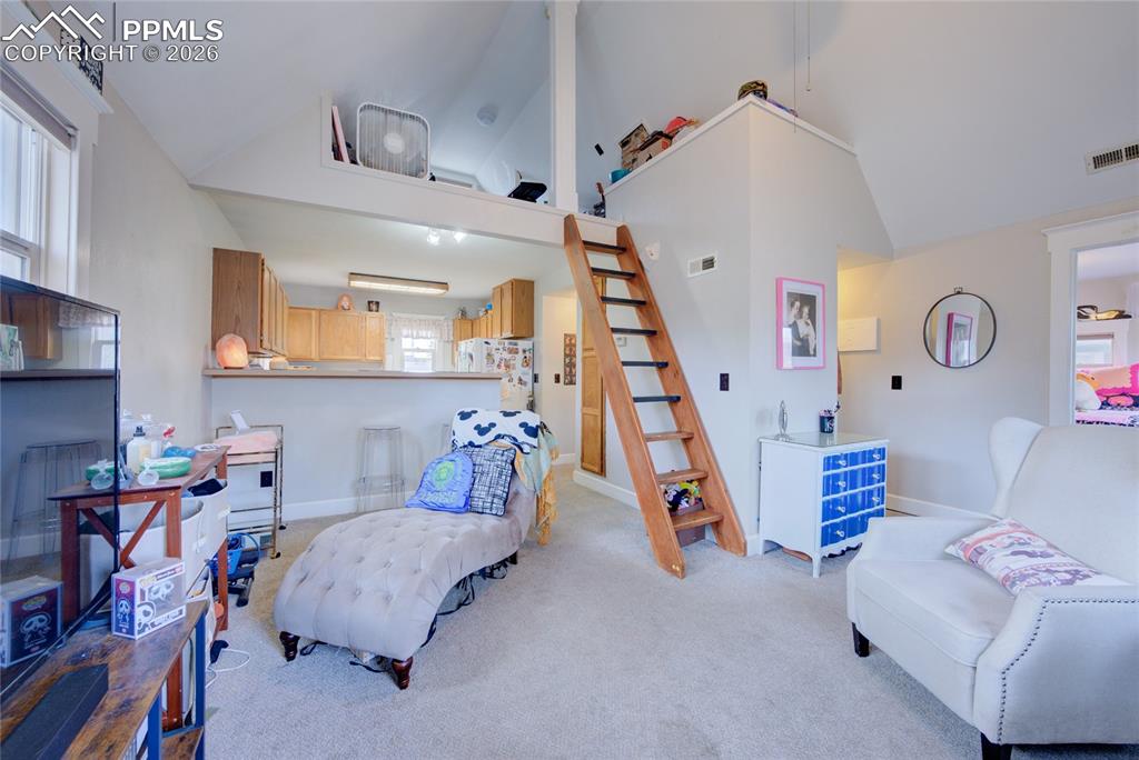 Image 18 of 33: view from living area showing loft and kitchen
