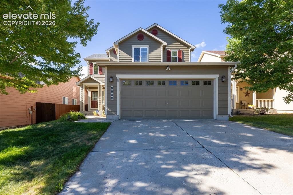 Image 1 of 39: Two-story residence featuring a two-car garage with transom window accents,