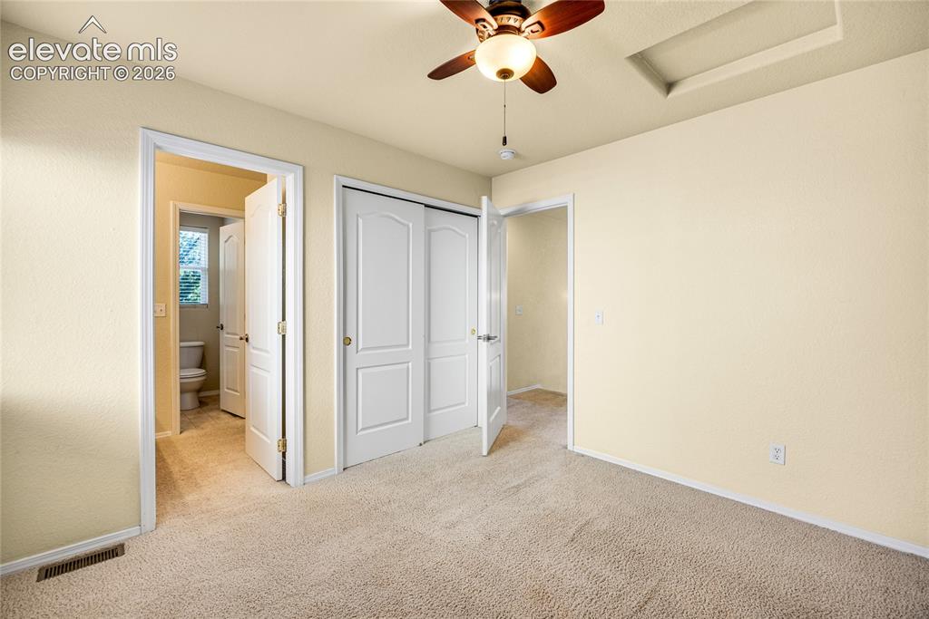 Image 22 of 39: Carpeted interior room featuring a ceiling fan with integrated lighting, a 