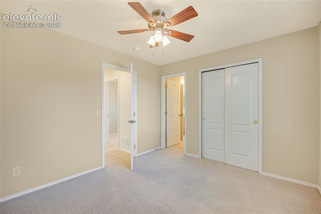 Image 25 of 39: Bedroom featuring neutral-toned walls, light-colored carpeting, a ceiling f