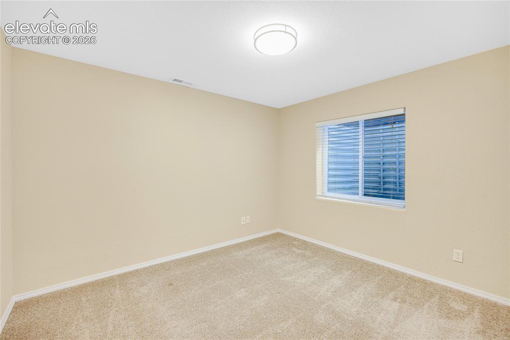 Image 28 of 39: Recessed window with white blinds, neutral carpeting, light beige walls, wh