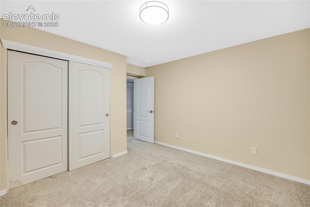 Image 29 of 39: Neutral-toned carpet flooring complementing beige wall paint