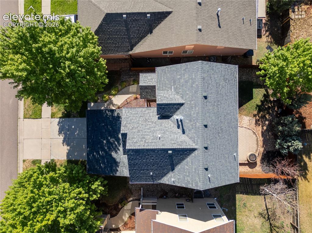 Image 4 of 39: Architectural shingle roofing on a multi-level structure with an attached d