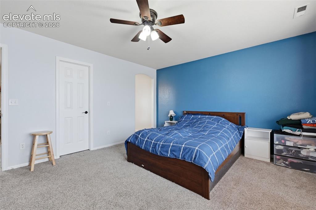 Image 17 of 21: Carpeted flooring, ceiling fan with integrated lighting, paneled interior d