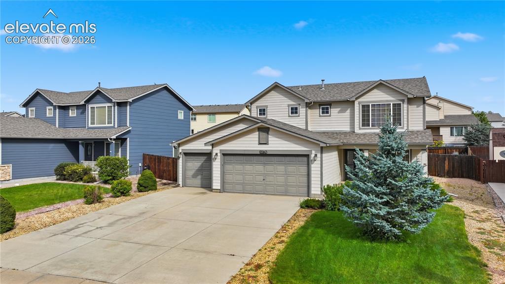 Image 2 of 21: Two-story exterior with light-colored siding, a multi-car driveway, and an 