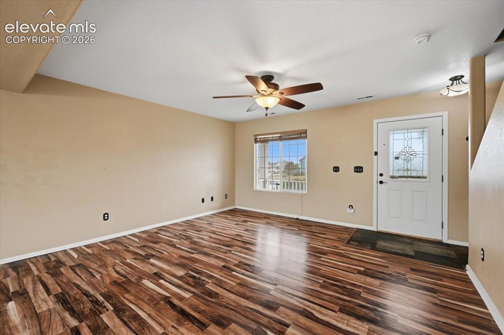 Image 6 of 26: Wood-finish flooring, decorative glass entry door, ceiling fan with integra