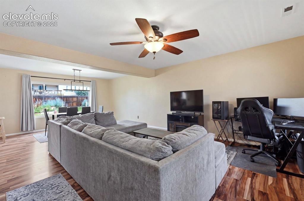 Image 7 of 21: Wood-finish flooring throughout, with a dining area featuring a modern line