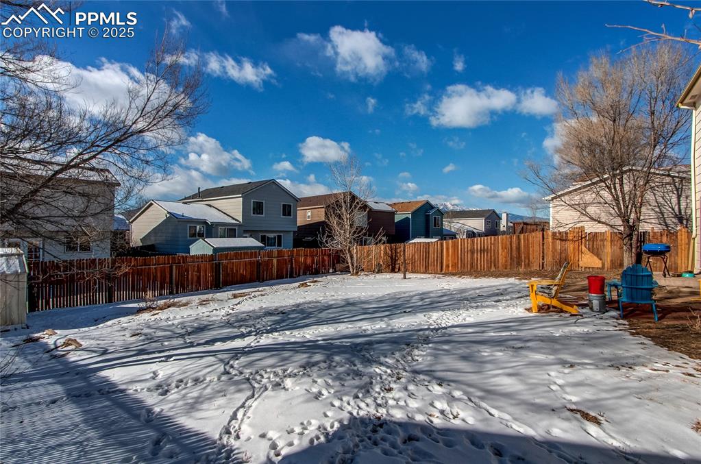 Image 35 of 36: View of yard covered in snow