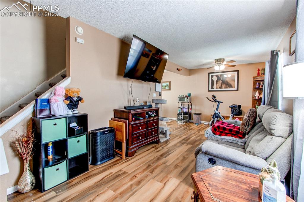 Image 5 of 36: Living room featuring ceiling fan, hardwood / wood-style floors, and a text