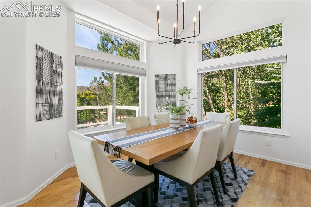 Image 18 of 50: Dining area featuring light wood-style flooring, a chandelier, and a toweri