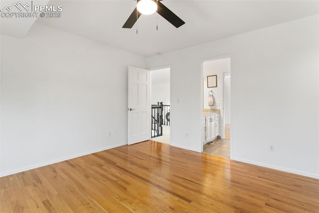Image 26 of 50: Unfurnished bedroom featuring light wood-style floors and ensuite bathroom