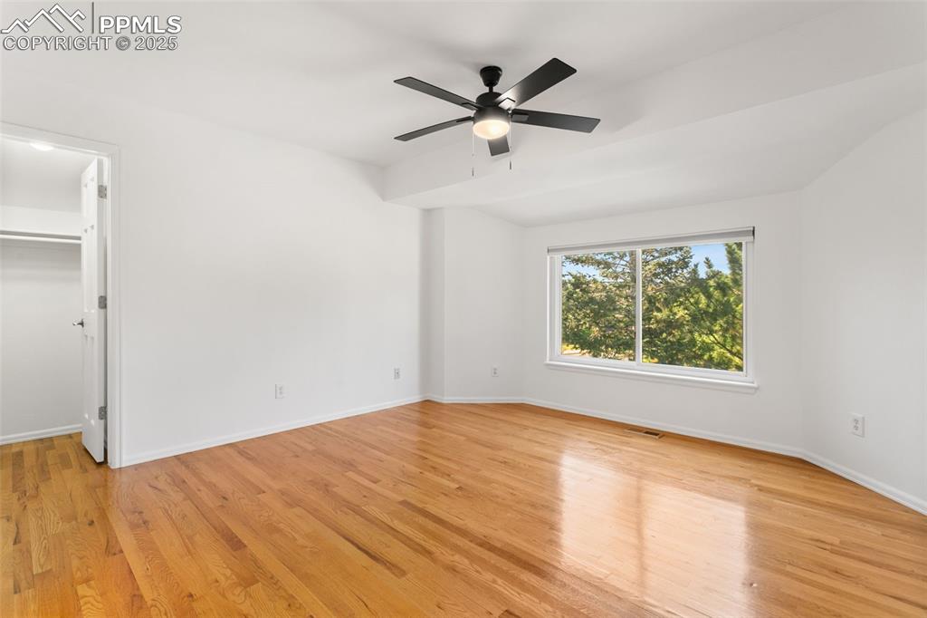 Image 27 of 50: Unfurnished bedroom featuring light wood finished floors, a walk in closet,