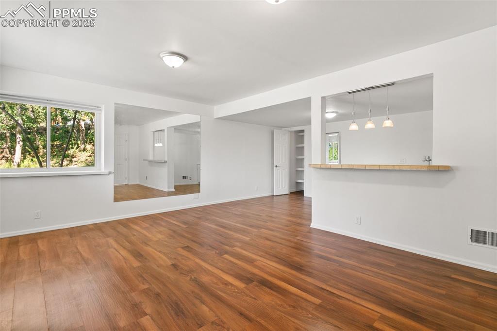 Image 39 of 50: Unfurnished living room featuring plenty of natural light and wood finished