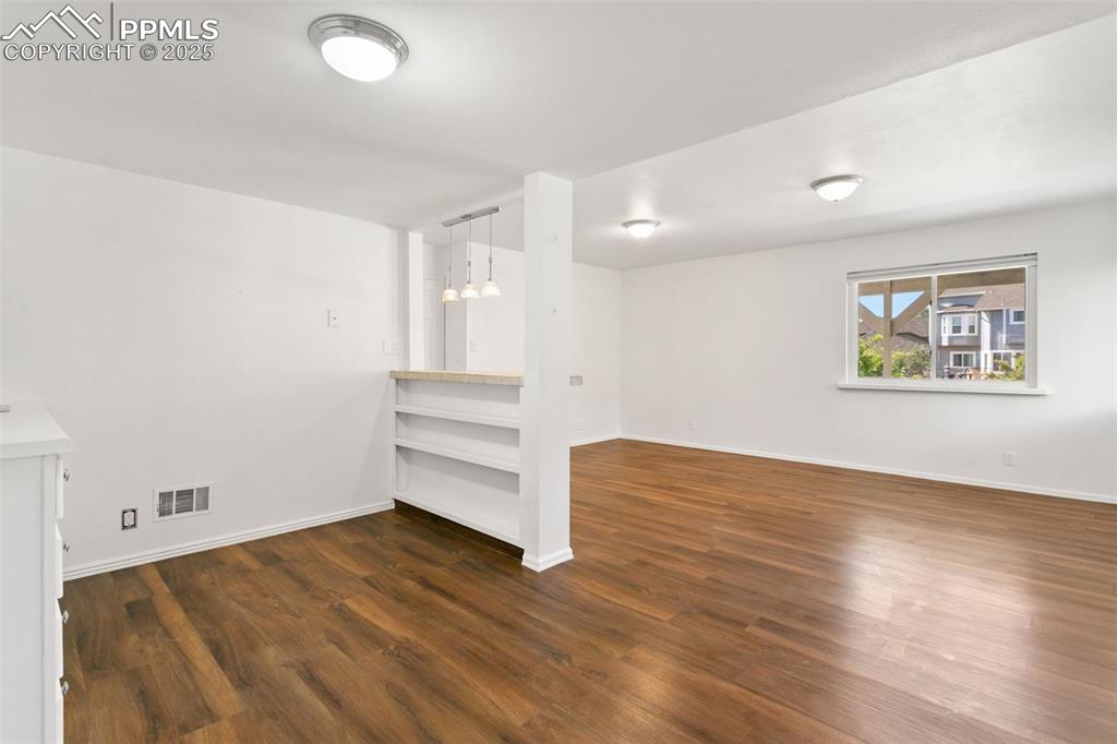 Image 41 of 50: Spare room featuring wood finished floors
