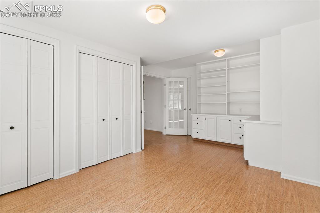 Image 44 of 50: Unfurnished bedroom featuring two closets and light wood-style floors