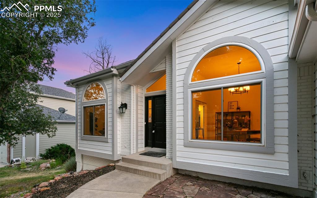 Image 6 of 50: View of exterior entry at dusk