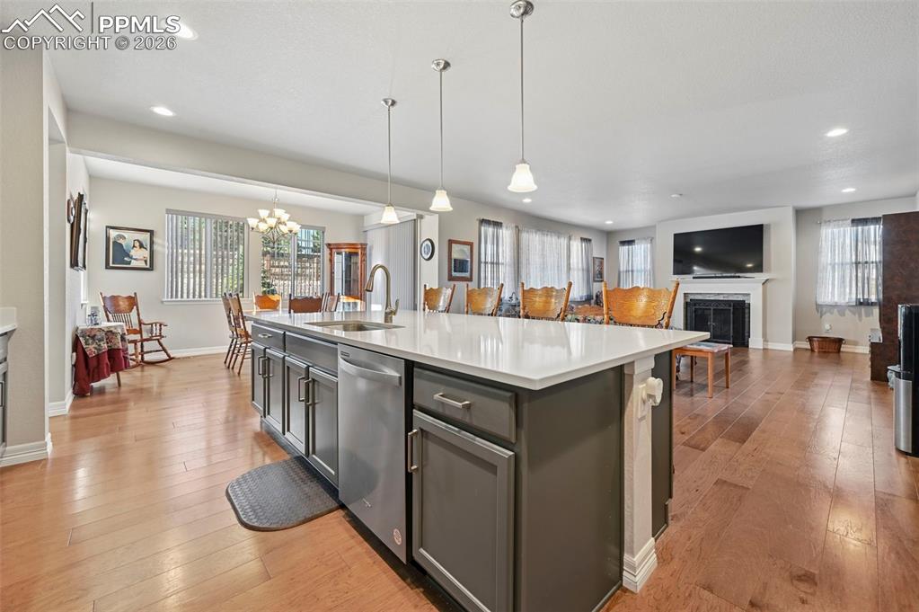 Image 17 of 48: Gourmet kitchen overlooking living room with fireplace and dining nook with