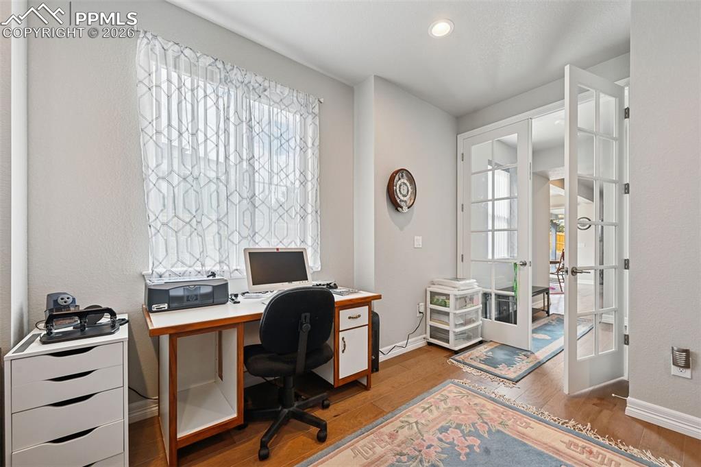 Image 21 of 48: Office tucked behind French doors