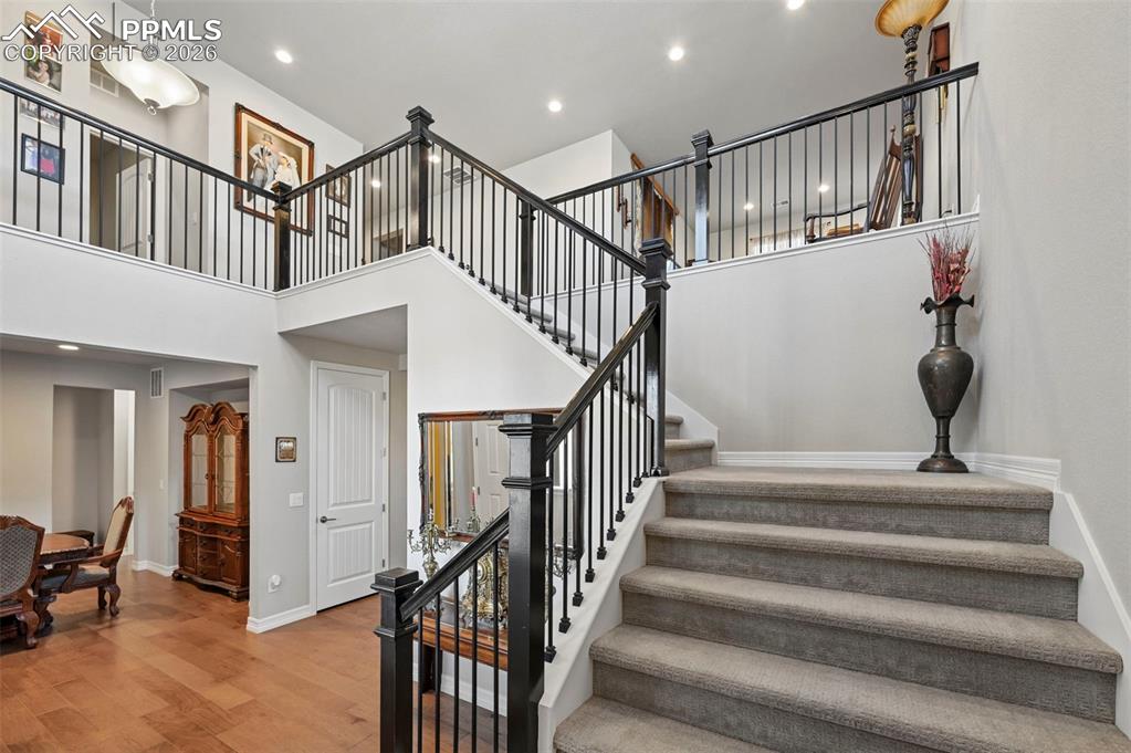 Image 6 of 48: Grand staircase at entry, looking up towards large loft space