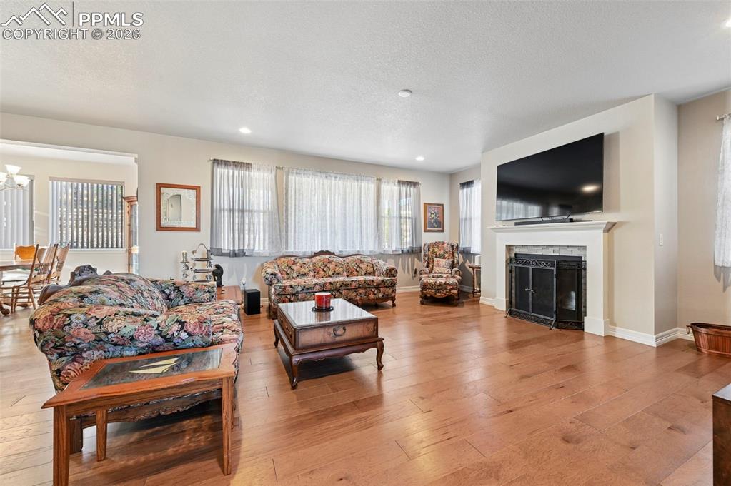 Image 9 of 48: Living room with fireplace and beautiful flooring throughout