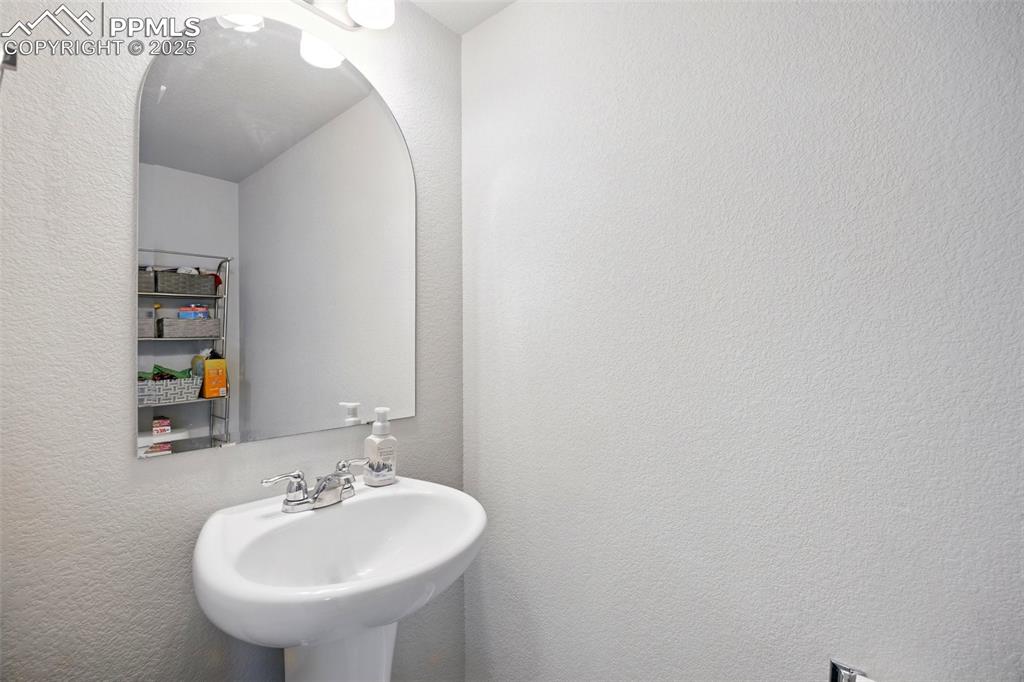 Image 16 of 46: Bathroom featuring a textured wall