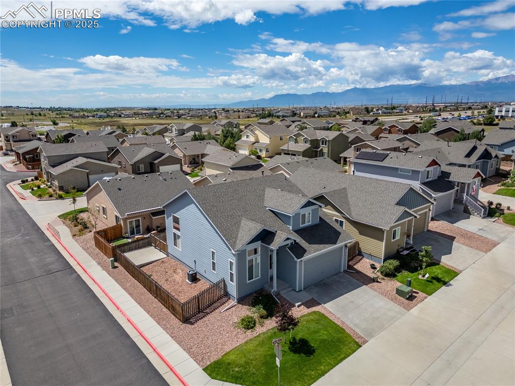 Image 34 of 46: Aerial view of residential area featuring mountains