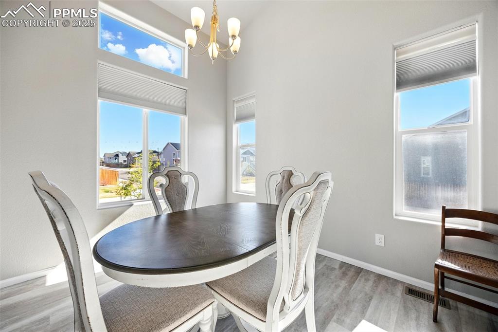 Image 9 of 46: Dining room featuring light wood-type flooring and a chandelier