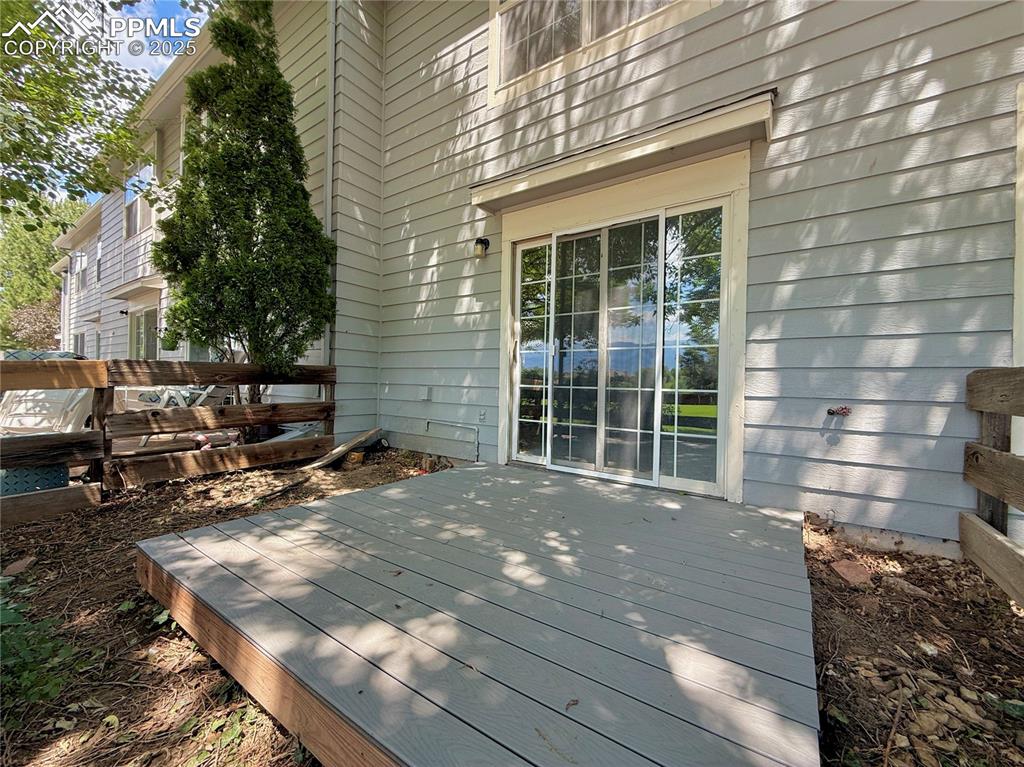 Image 19 of 23: West facing deck at the back of the home.