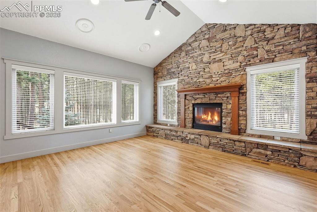 Image 18 of 50: View of trees from Family Room/Den, which also boasts a ceiling fan, and a 