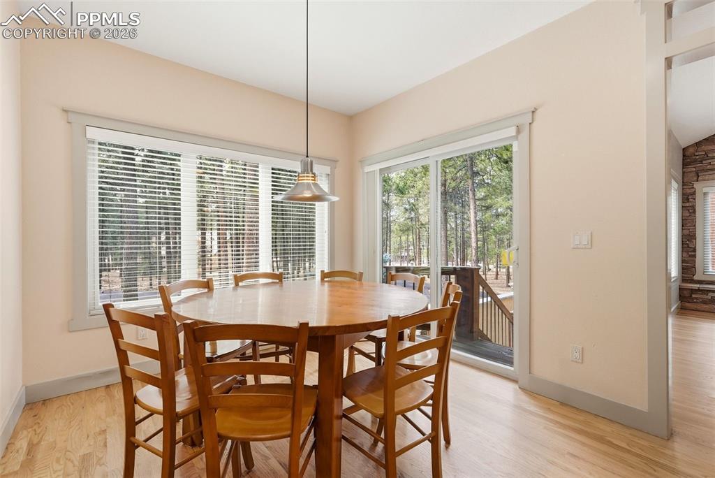 Image 26 of 50: Dining room featuring oak wood flooring and baseboards and great windows