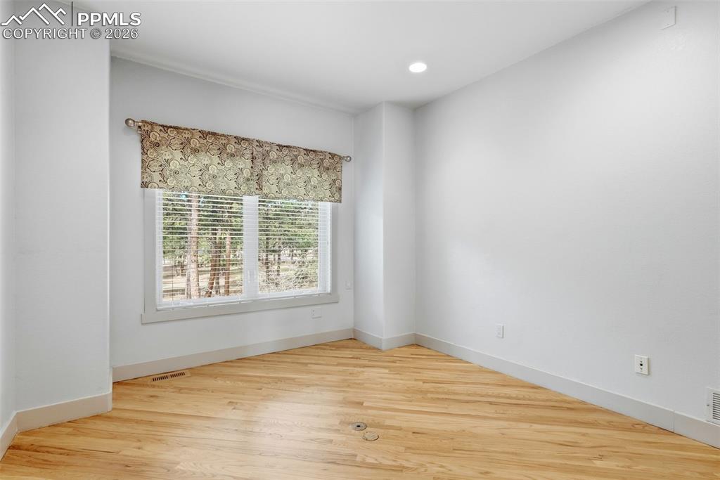 Image 27 of 50: Office room featuring wood floors, valance, recessed lighting