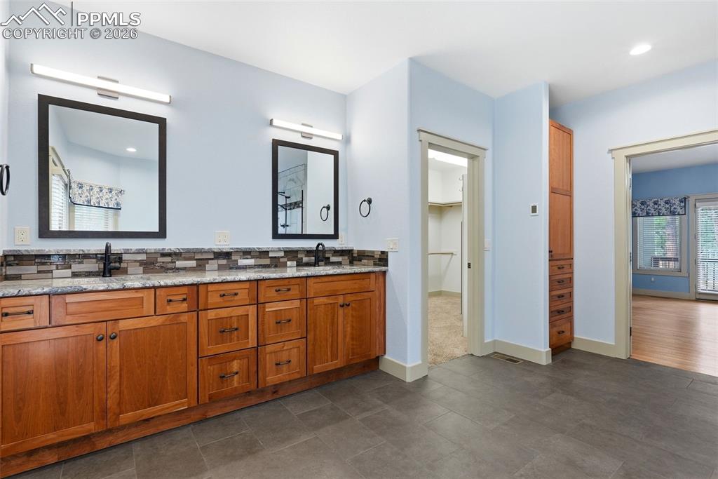 Image 33 of 50: Full bath with double vanity, backsplash, and recessed lighting