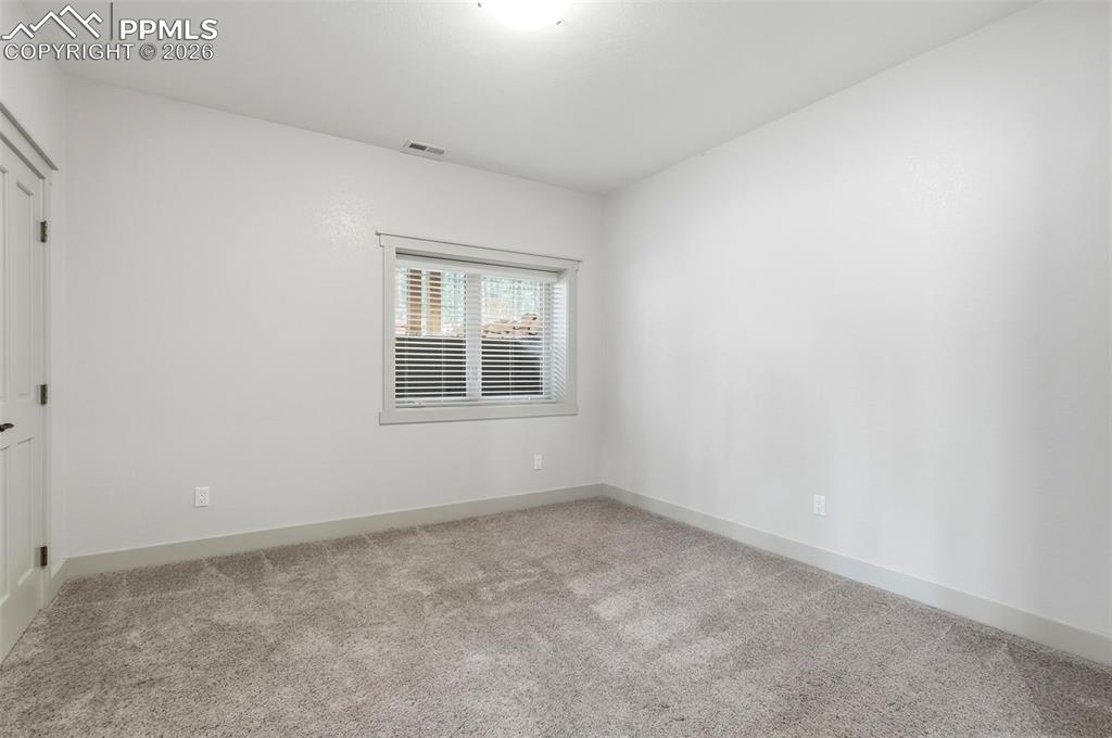 Image 44 of 50: 3rd Bedroom featuring light carpet and baseboards