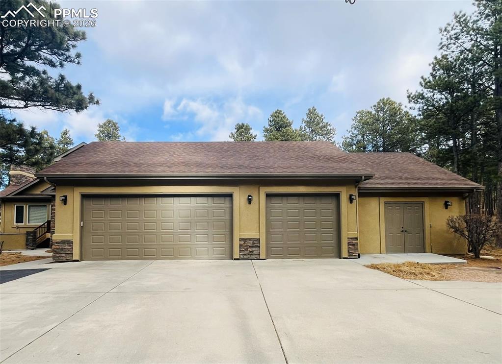 Image 6 of 50: 3 Car garage plus 4th garage storage bay and concrete basketball pad