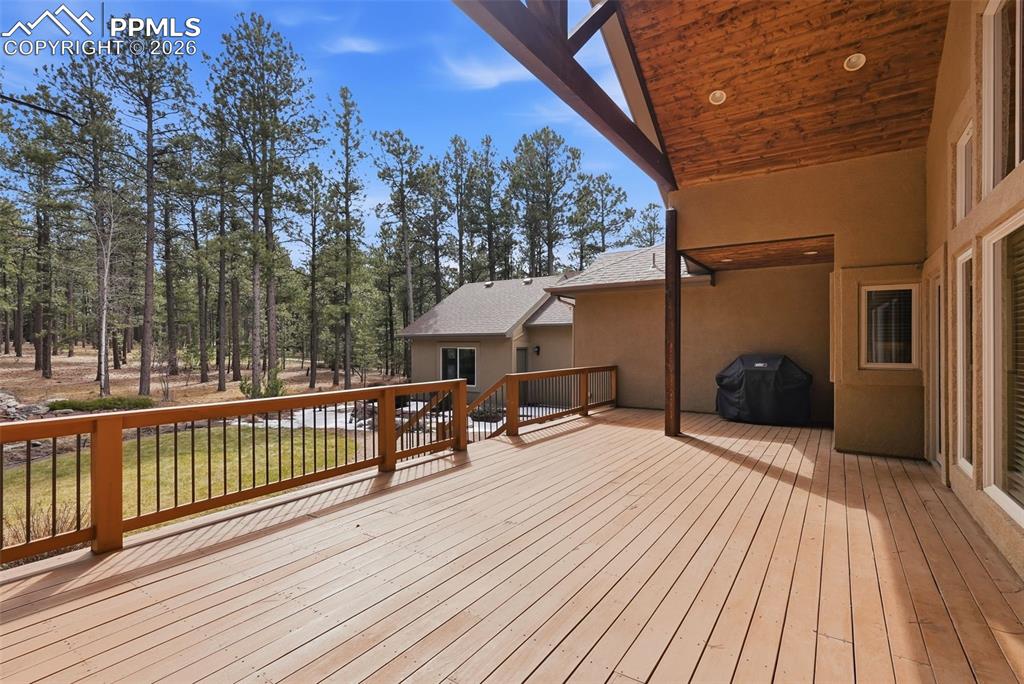 Image 7 of 50: Partially covered deck with gas grill connection and wired for outdoor spea