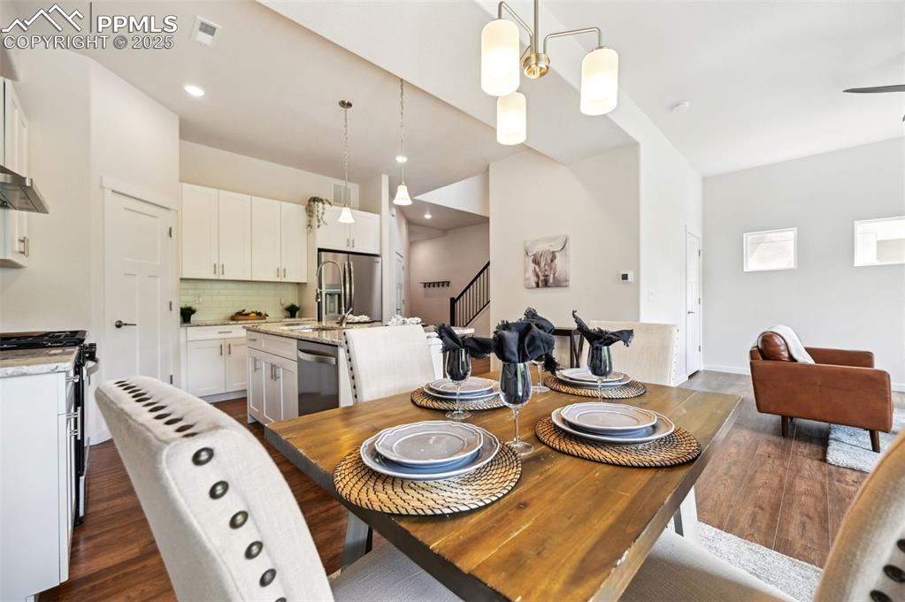 Image 11 of 30: Dining Area with view into the Kitchen and Living Room.