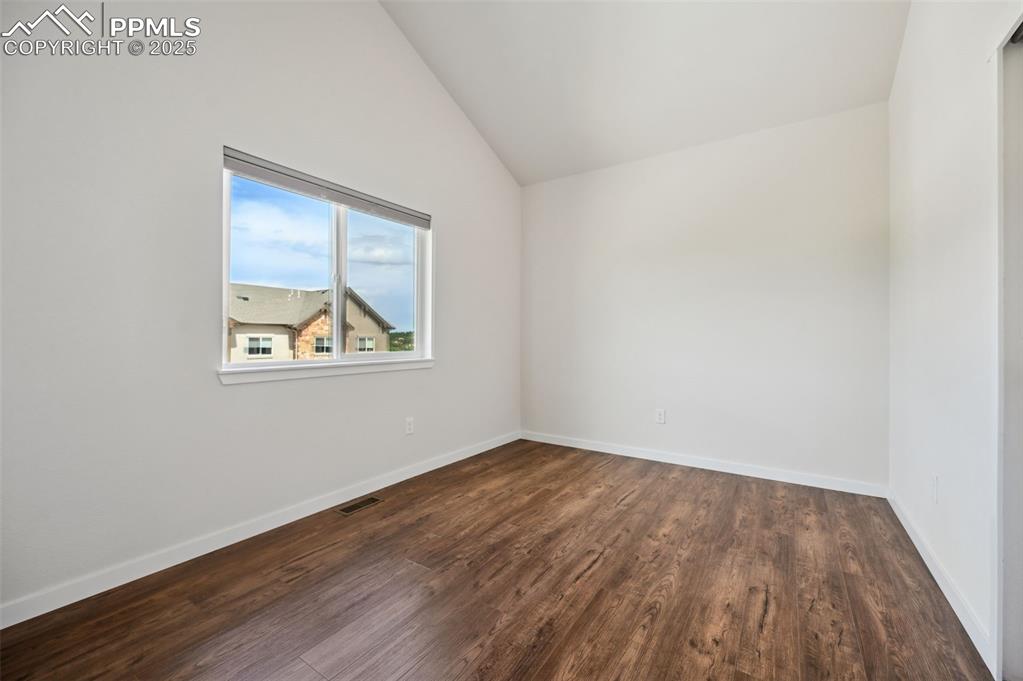 Image 25 of 30: Upper Level Bedroom #2 with luxury vinyl plank floors.