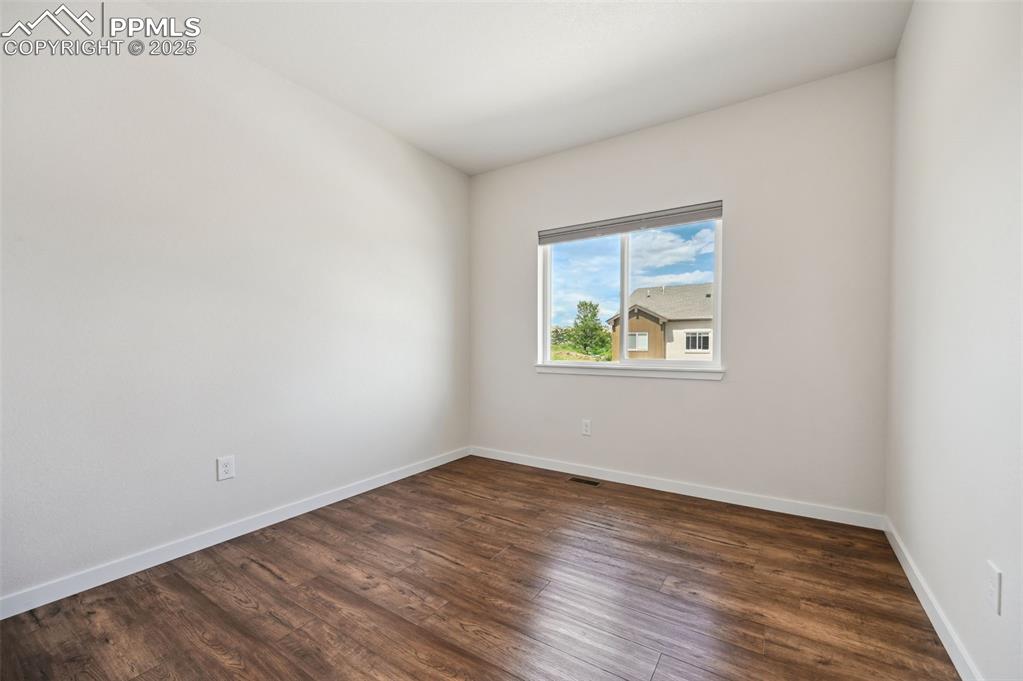 Image 28 of 30: Upper Level Bedroom #3 with luxury vinyl plank floors.