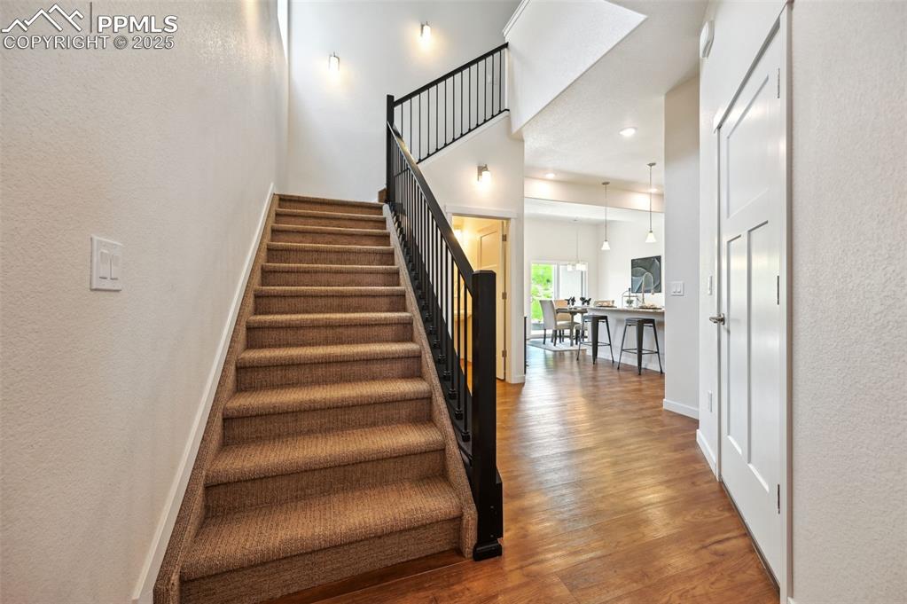 Image 3 of 30: Front Entry with iron stair rails to the upper level.