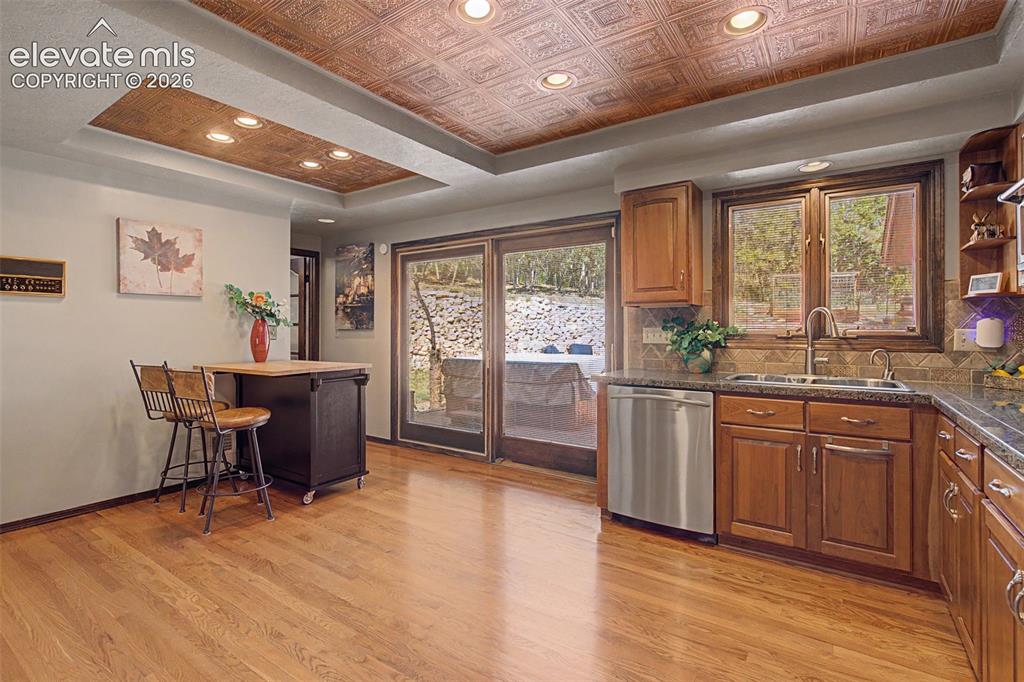 Image 18 of 50: Easy access to rear patio from the kitchen. A perfect place for al fresco d
