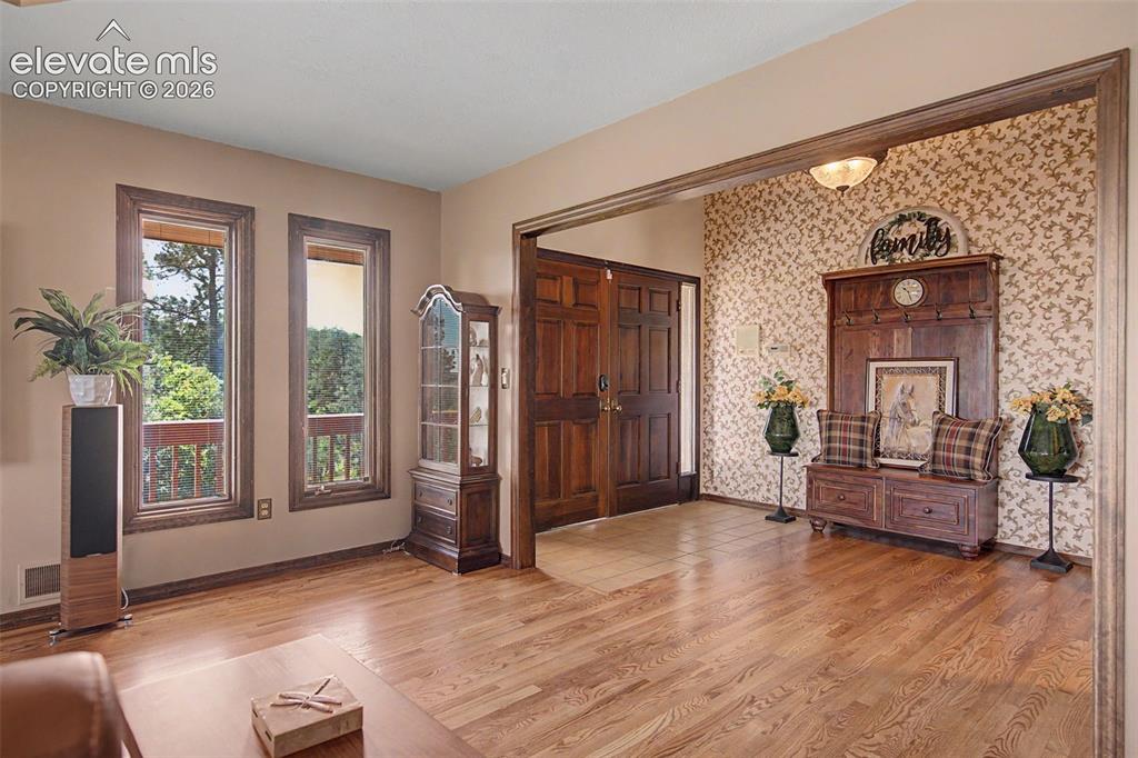Image 6 of 50: Open concept front entry welcome your guests inside with a modern luxurious