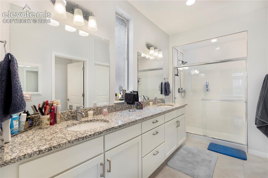 Image 15 of 25: Master Bathroom with 2 vanites and walkin shower