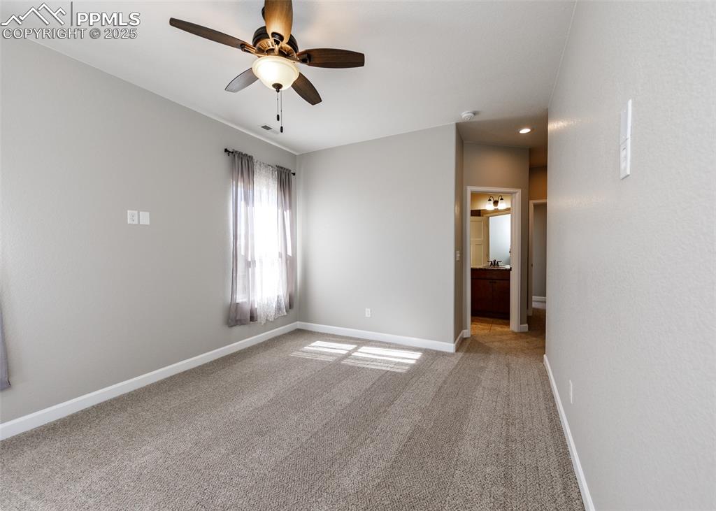 Image 17 of 27: Another view of the primary bedroom looking into the bath.