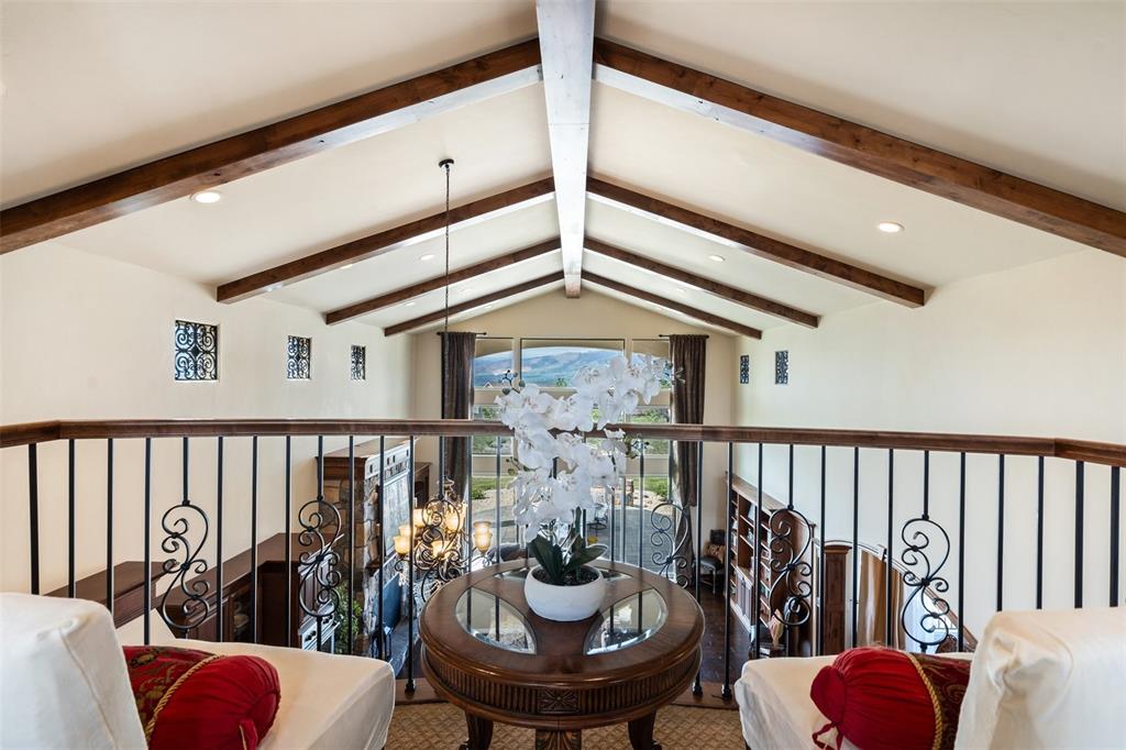Image 21 of 50: Second-story overlook with beamed ceiling and open sightlines.