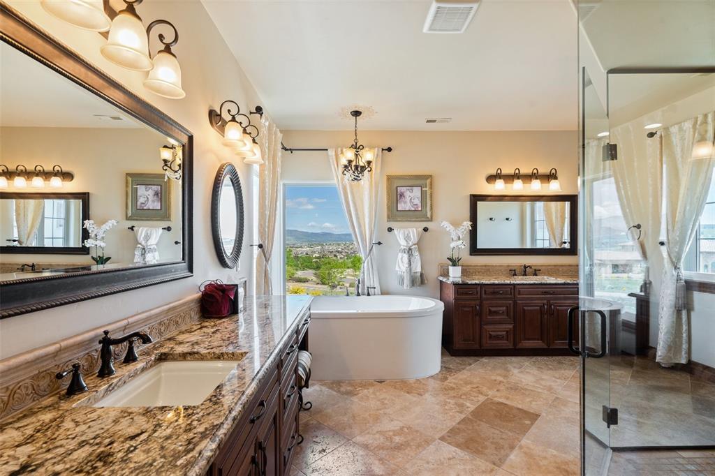 Image 26 of 50: Luxurious 5-piece master bath with a soaking tub, dual vanities, and Spa sh