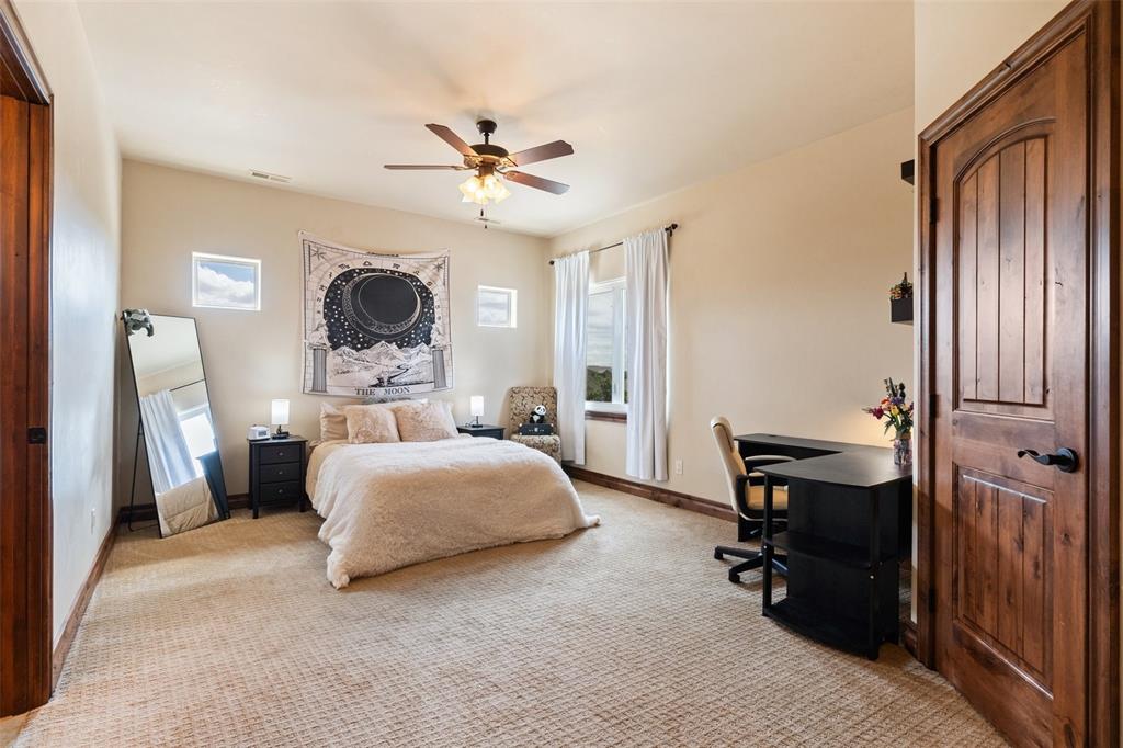 Image 32 of 50: Upper-level bedroom  with generous space and natural light.