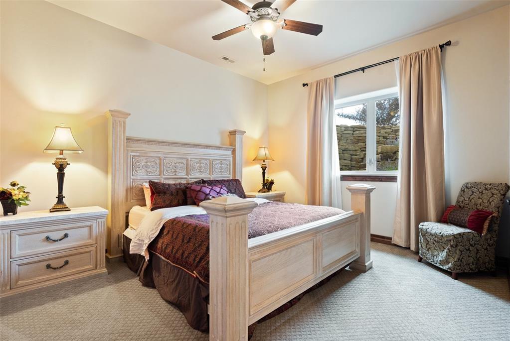 Image 39 of 50: Bright lower-level junior suite bedroom, thanks to landscaping designed to 