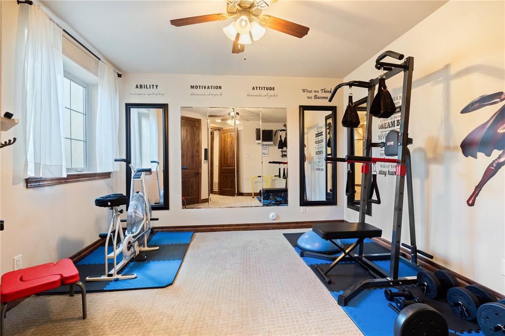 Image 43 of 50: Versatile lower-level bedroom currently showcased as a home gym studio