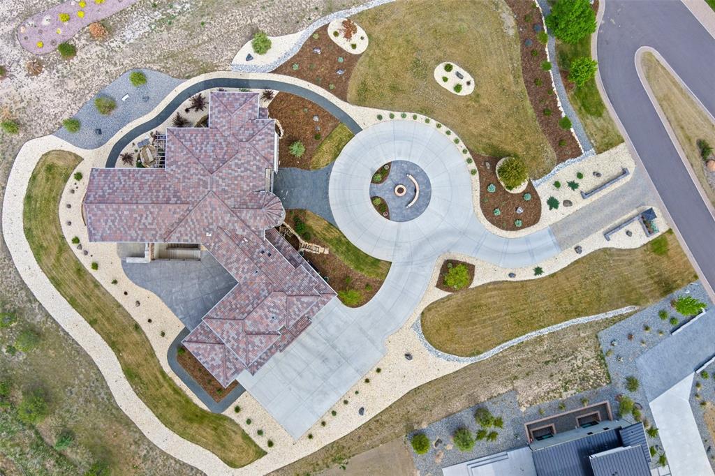 Image 49 of 50: Aerial view showcasing the circular drive, extensive hardscaping, and beaut